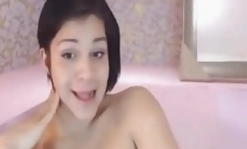 tranny with stroke her big penis on a pink cot