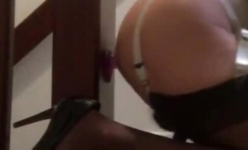 Crossdresser fucks a dildo in stockings and heels