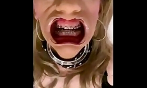 Alexandra Braces is masturbating and dildo fucking while wearing an open mouth expander