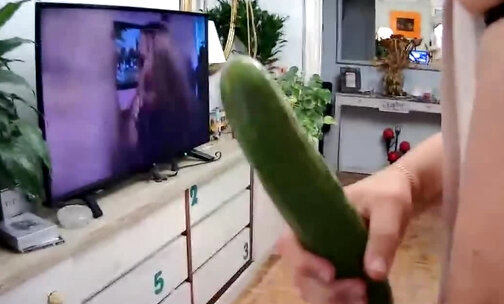 The whore fucks her ass with a cucumber