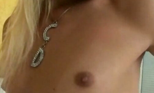 A hot blonde with small tits is masturbating